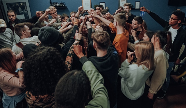 Youth group huddle with hands reaching toward center